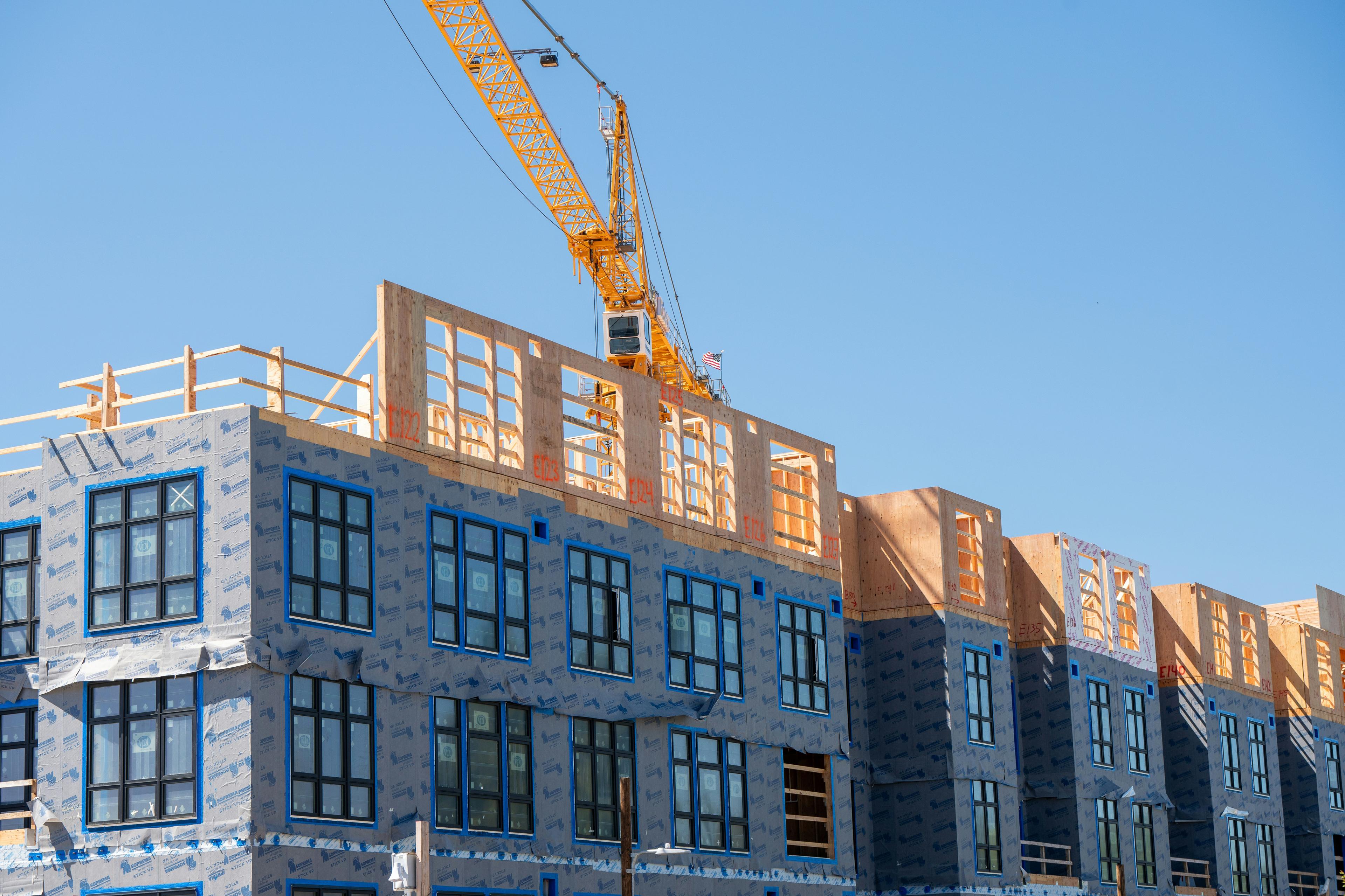 Multi-family and commercial construction site with crane in Dallas-Fort Worth